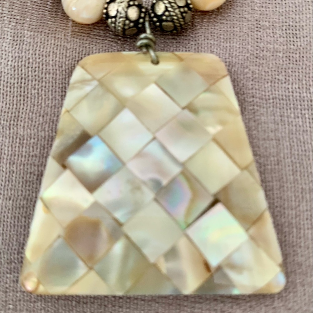Double strand necklace with unique mother of pearl pendant